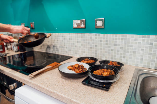 Sunday meal prep session with oven trays and containers